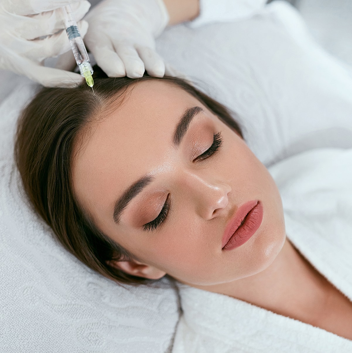 Woman receiving hair treatment injection.