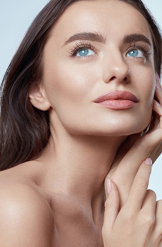 Woman with smooth skin and blue eyes.