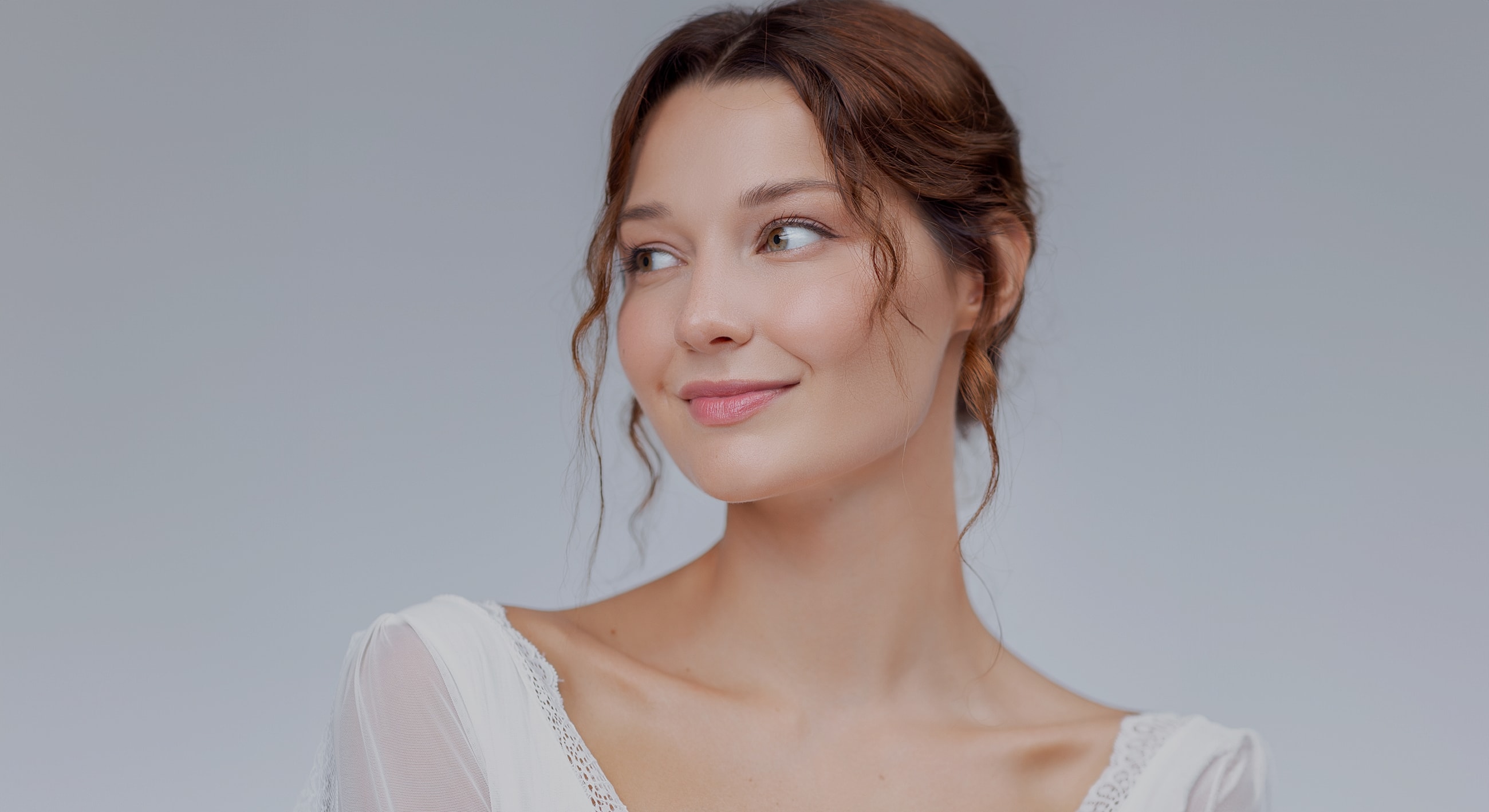 Woman smiling with soft, natural makeup.